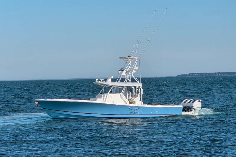 Slide: The Image of 2016 Regulator 41 boat cruising on open water under clear blue skies. - 2