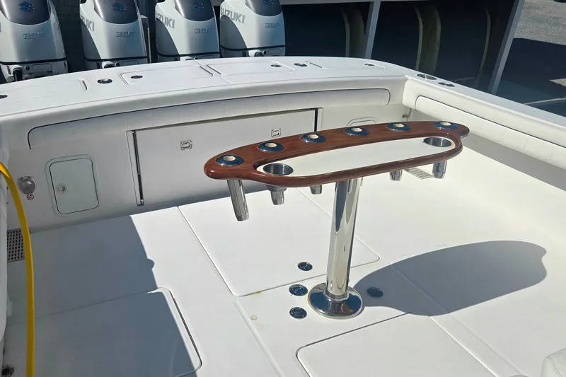 Slide: The Image of 2016 Regulator 41 boat deck with rod holders and Suzuki engines in background. - 24