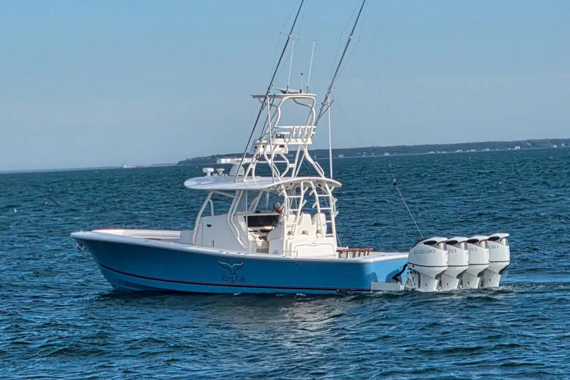 Slide: The Image of 2016 Regulator 41 boat with four Suzuki outboard engines on open water. - 4