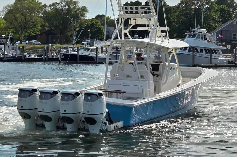 Slide: The Image of 2016 Regulator 41 boat with four outboard engines cruising in a marina. - 5