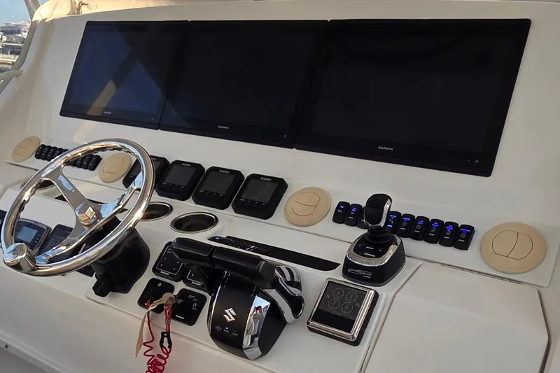 Slide: The Image of Control panel of a 2016 Regulator 41 boat with steering wheel and navigation screens. - 9