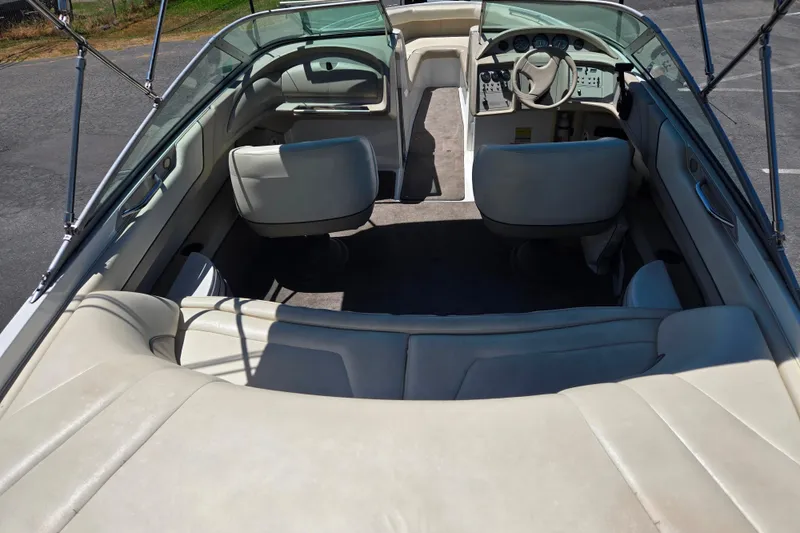 Slide: The Image of Interior of a 1996 Cobalt 232 boat with white leather seating and steering console. - 2