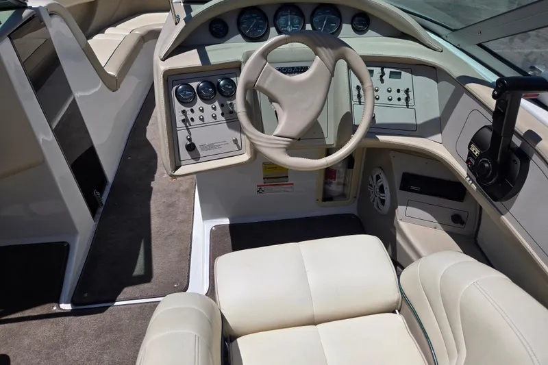 Slide: The Image of Interior of a 1996 Cobalt 232 boat, featuring steering wheel and control panel. - 6