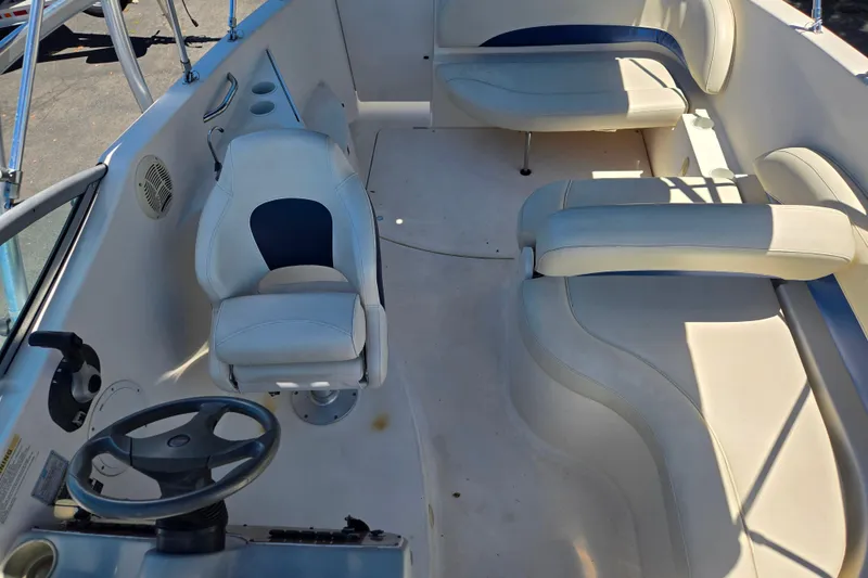 Slide: The Image of 2006 Bayliner 265 boat interior with steering wheel and seating area. - 11
