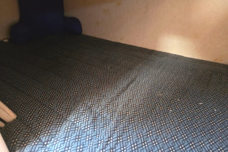 Slide: The Image of Interior cabin of a 2006 Bayliner 265 boat with patterned bedding. - 18
