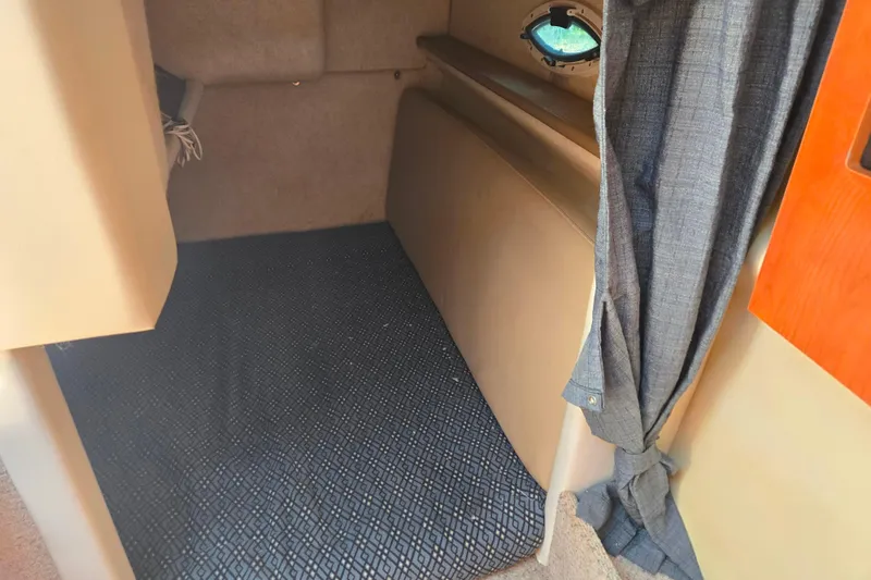 Slide: The Image of Interior cabin of a 2006 Bayliner 265 boat with carpet and curtain. - 19