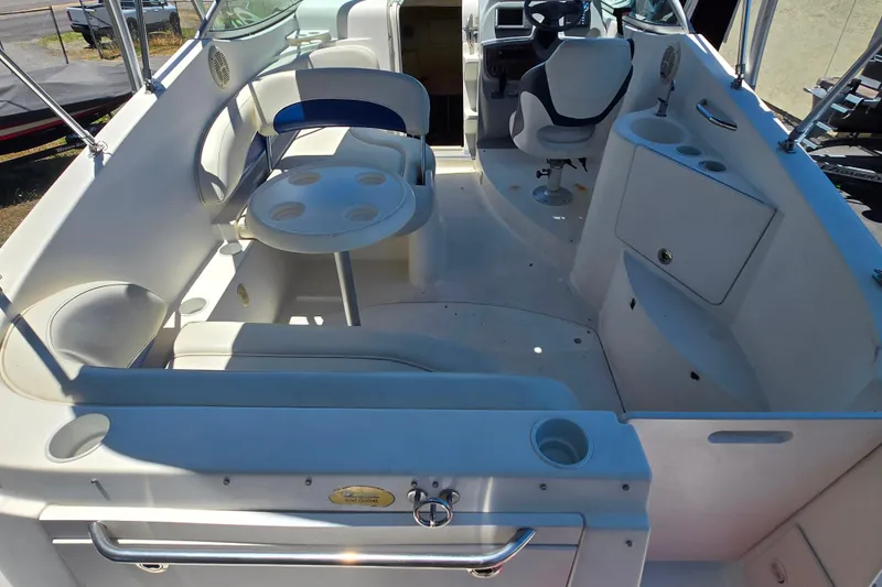 Slide: The Image of 2006 Bayliner 265 boat interior with seating, table, and helm station. - 23