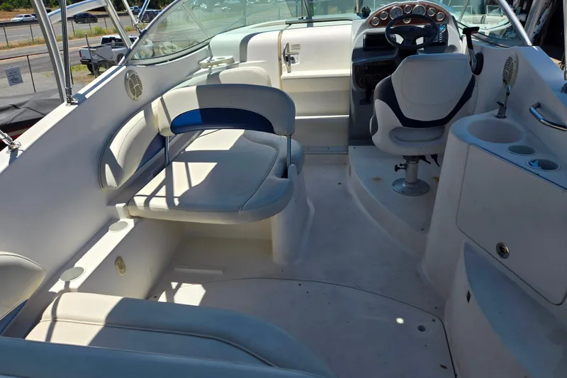 Slide: The Image of Interior of a 2006 Bayliner 265 boat featuring seating and steering area. - 5