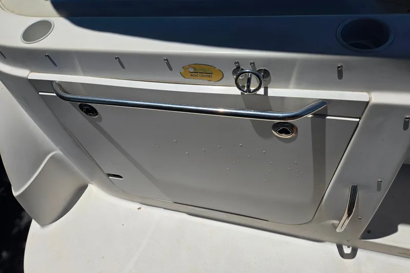 Slide: The Image of 2006 Bayliner 265 boat deck with stainless steel railing and storage compartment. - 6