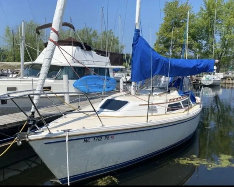 Slide: The Image of 1990 Catalina 28 sailboat docked at marina. - 2