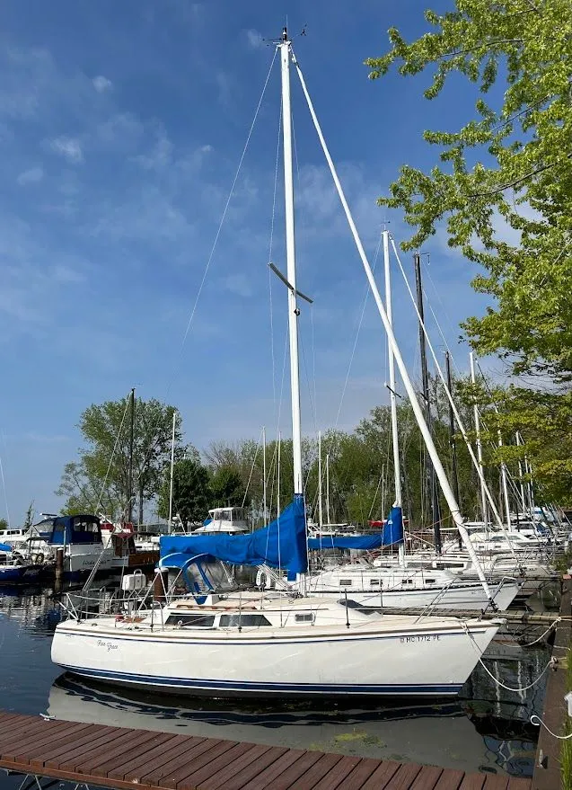 Slide: The Image of 1990 Catalina 28 sailboat docked in marina on a sunny day. - 3