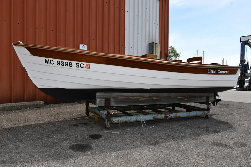 The Image of 2003 Great Lakes 16 Skiff boat named "Little Current" on a trailer, dockside. - 0