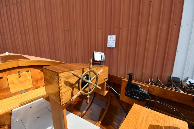 Slide: The Image of Wooden interior of a 2003 Great Lakes 16 Skiff boat with steering wheel. - 11
