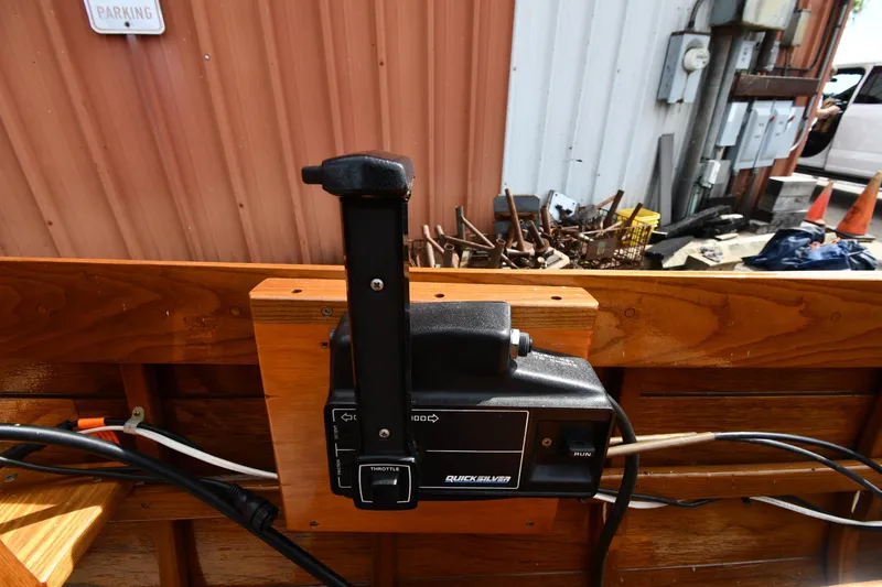 Slide: The Image of Throttle control of a 2003 Great Lakes 16 Skiff boat, mounted on wooden panel. - 13