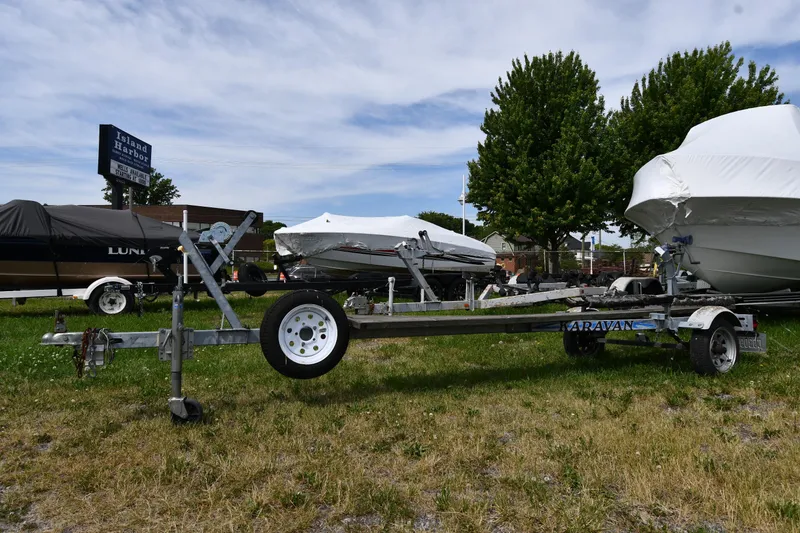 Slide: The Image of Boat trailer at Island Harbor with covered Great Lakes 16 Skiff, 2003 model, in background. - 18
