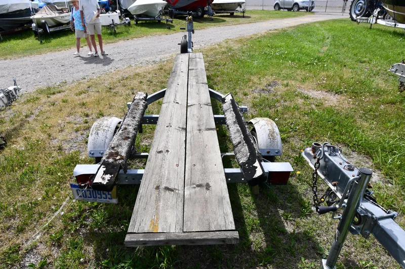 Slide: The Image of Boat trailer for 2003 Great Lakes 16 Skiff on grassy lot with other boats. - 19