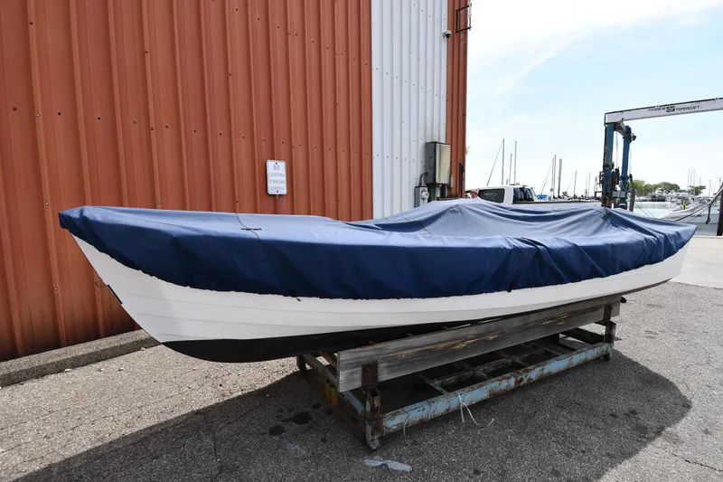 Slide: The Image of 2003 Great Lakes 16 Skiff boat covered with blue tarp, docked near marina. - 21