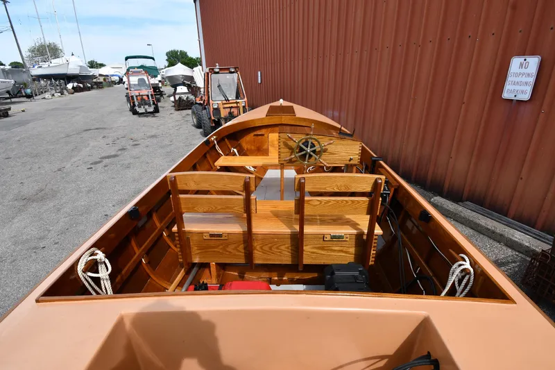 Slide: The Image of 2003 Great Lakes 16 Skiff boat with wooden interior, docked near a red building. - 7