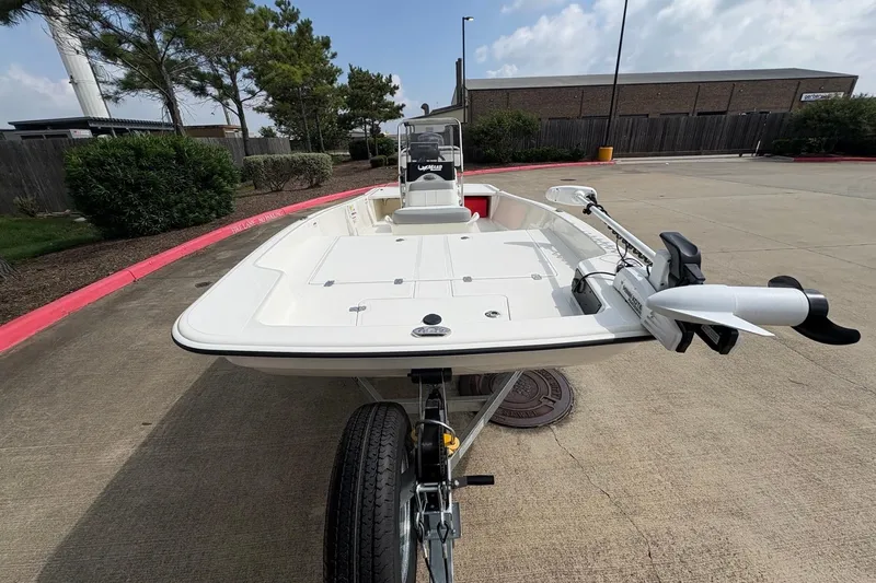 Slide: The Image of 2026 Mako Pro Skiff 17 CC boat on trailer, parked outdoors. - 2