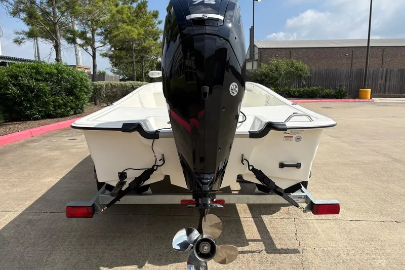 Slide: The Image of 2026 Mako Pro Skiff 17 CC boat on trailer, rear view with outboard motor. - 7
