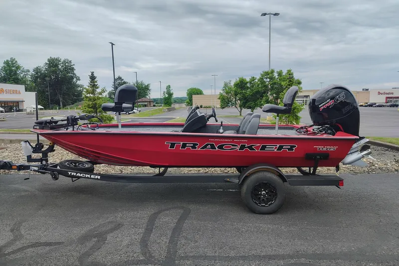 The Image of Red 2026 Tracker Pro Team 195 boat on trailer in parking lot. - 0