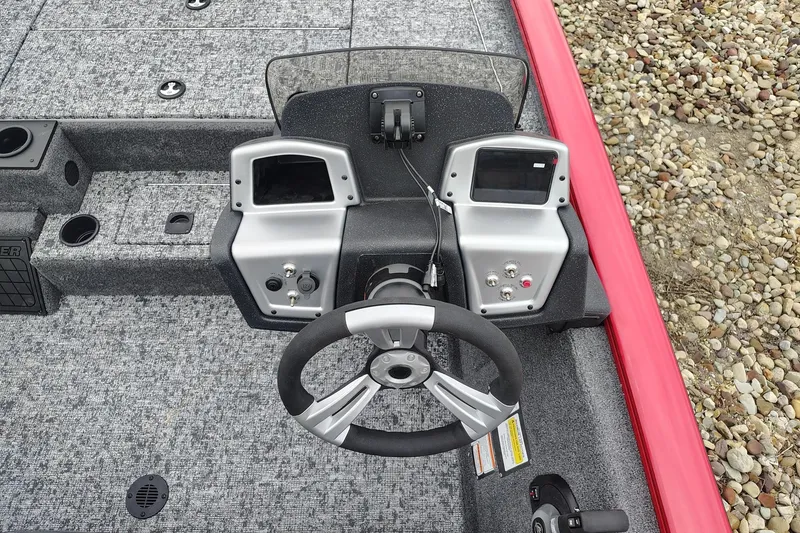 Slide: The Image of 2026 Tracker Pro Team 195 boat dashboard with dual displays and steering wheel. - 3
