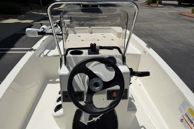 Slide: The Image of 2026 Mako Pro Skiff 15 CC boat interior with steering wheel and console. - 8