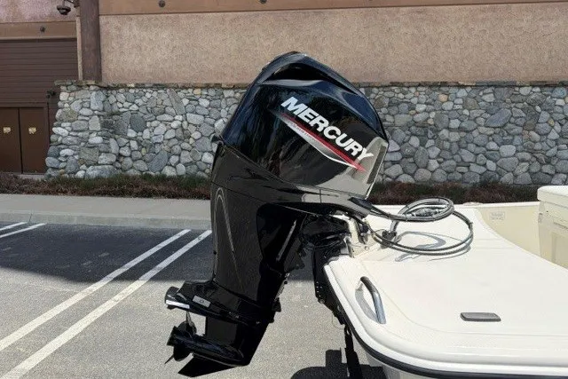 Slide: The Image of 2026 Mako Pro Skiff 15 CC with Mercury outboard motor in parking lot. - 5