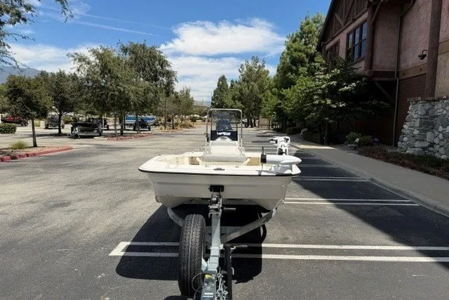 Slide: The Image of 2026 Mako Pro Skiff 15 CC boat on trailer in parking lot. - 3