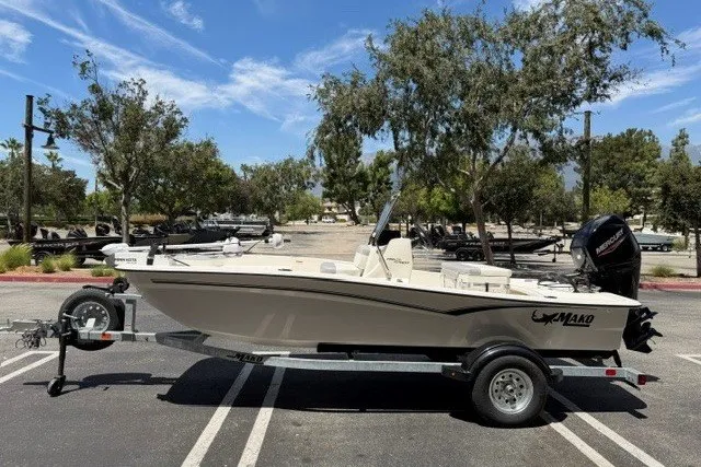 Slide: The Image of 2026 Mako Pro Skiff 15 CC boat on trailer in parking lot. - 1