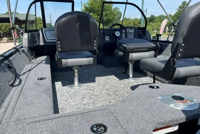 Slide: The Image of 2026 Tracker Pro Guide V-16 WT boat interior with seating and dashboard, showcasing modern design. - 3