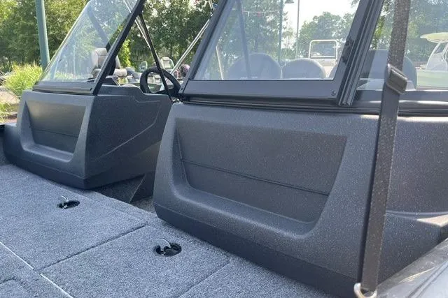 Slide: The Image of 2026 Tracker Pro Guide V-16 WT boat interior with windshield and seating. - 7