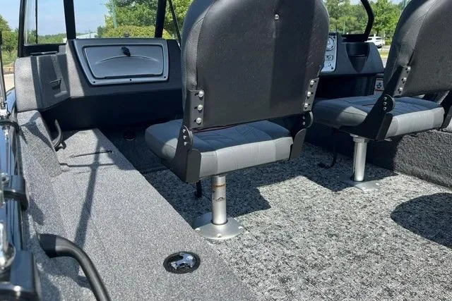 Slide: The Image of 2026 Tracker Pro Guide V-16 WT boat interior with two seats and carpeted flooring. - 6
