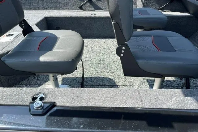Slide: The Image of 2026 Tracker Pro Guide V-16 WT boat interior with gray seating and carpeted floor. - 5