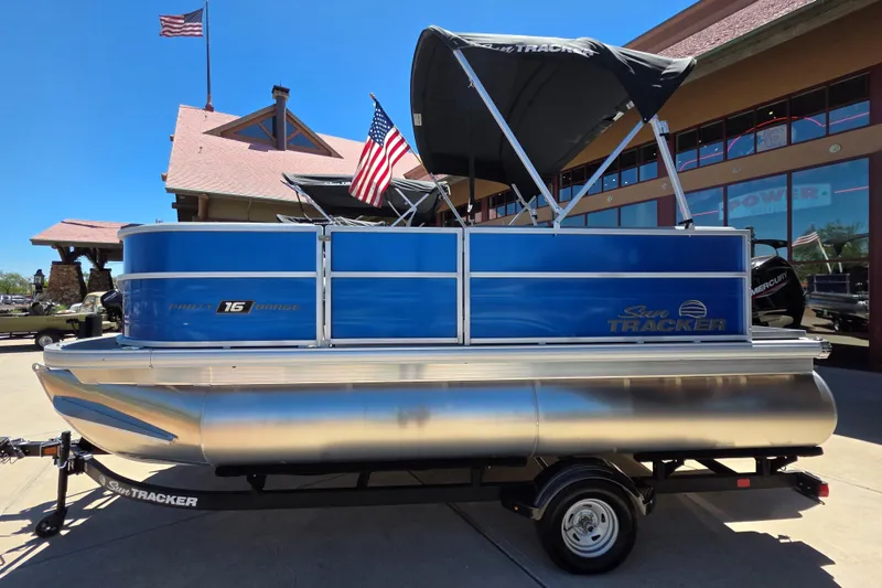 Slide: The Image of 2026 Sun Tracker Party Barge 16 DLX pontoon boat with blue exterior and canopy. - 62