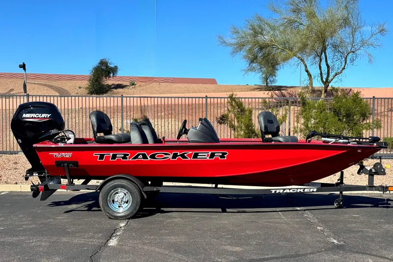The Image of 2026 Tracker Pro Team 175 Crappie Edition boat, red, on trailer, outdoors. - 0