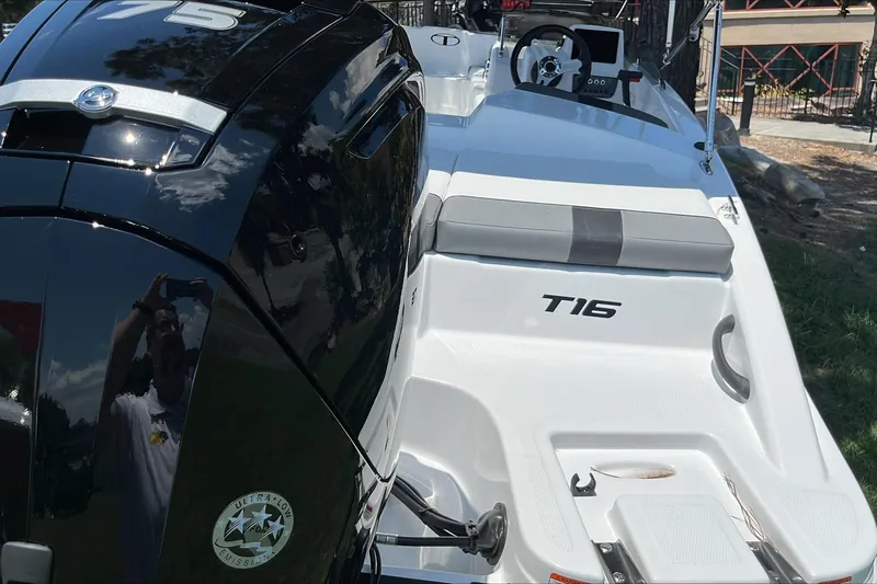 Slide: The Image of 2026 Tahoe T16 boat with sleek design and powerful engine, parked outdoors. - 5