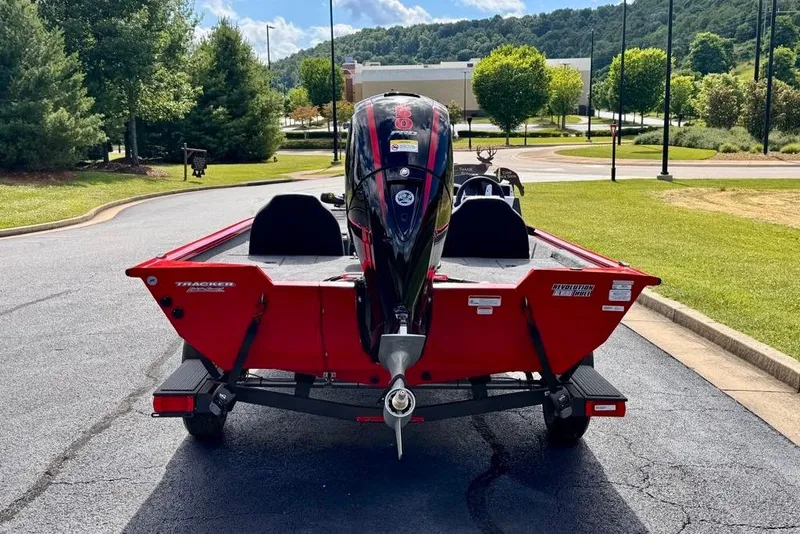 Slide: The Image of 2026 Tracker Pro Team 195 boat on trailer, parked on a scenic road. - 5