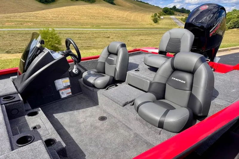 Slide: The Image of 2026 Tracker Pro Team 195 boat interior with gray seating and steering console. - 7