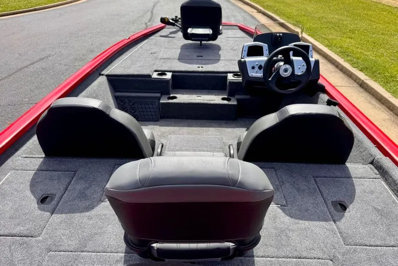 Slide: The Image of 2026 Tracker Pro Team 195 boat interior with steering console and seating, featuring a sleek design. - 9