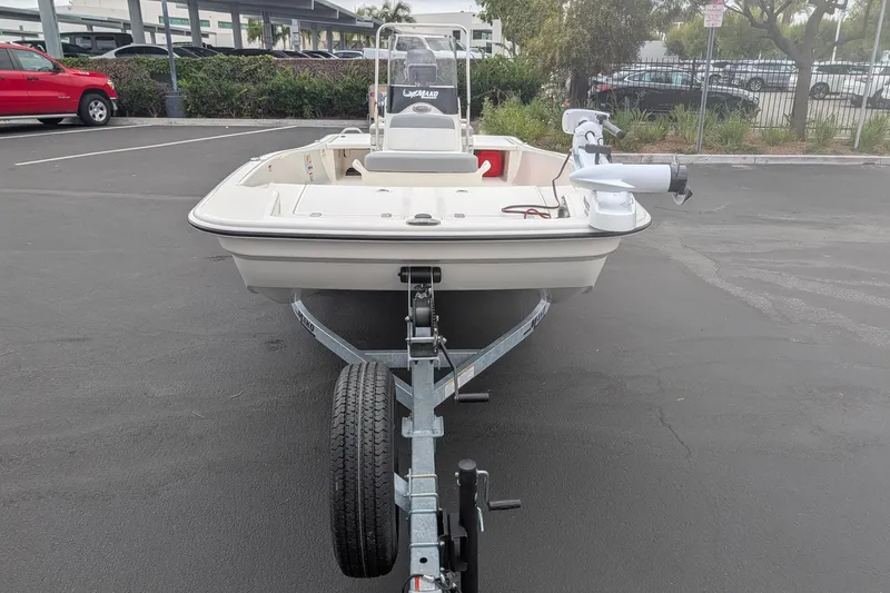 Slide: The Image of 2026 Mako Pro Skiff 15 CC boat on trailer in parking lot. - 2