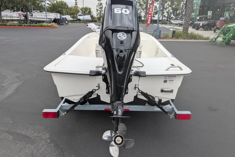Slide: The Image of 2026 Mako Pro Skiff 15 CC with 60 HP outboard motor on trailer. - 3