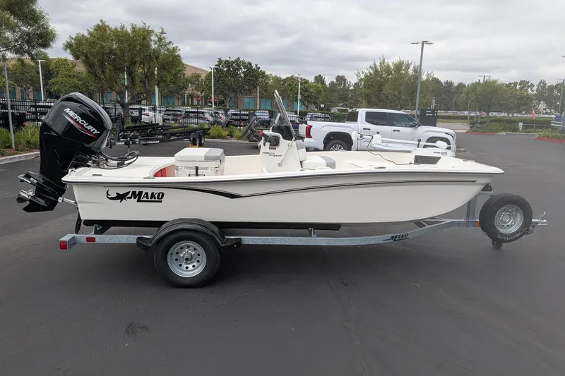 Slide: The Image of 2026 Mako Pro Skiff 15 CC boat on trailer, parked outdoors. - 4