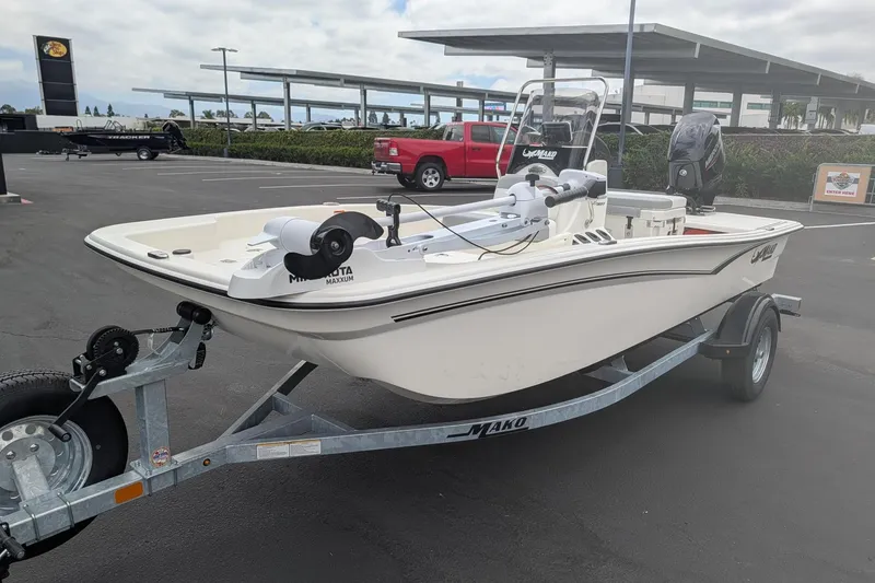 Slide: The Image of 2026 Mako Pro Skiff 15 CC boat on trailer in parking lot. - 5