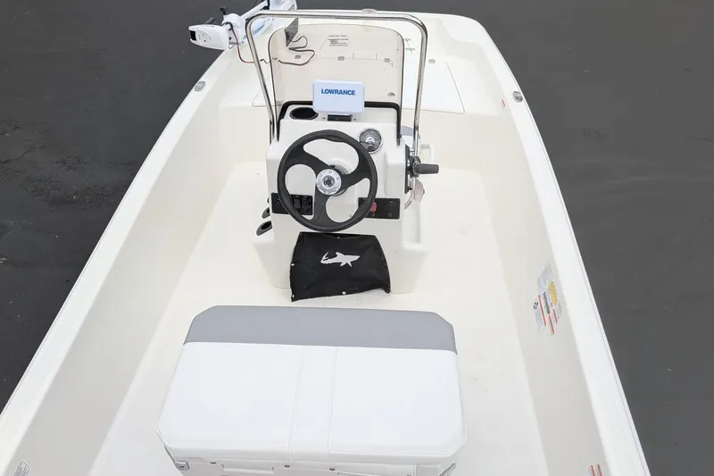 Slide: The Image of 2026 Mako Pro Skiff 15 CC boat interior with steering console and seating. - 6