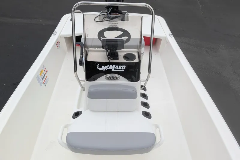 Slide: The Image of 2026 Mako Pro Skiff 15 CC boat interior with steering console and seating. - 8