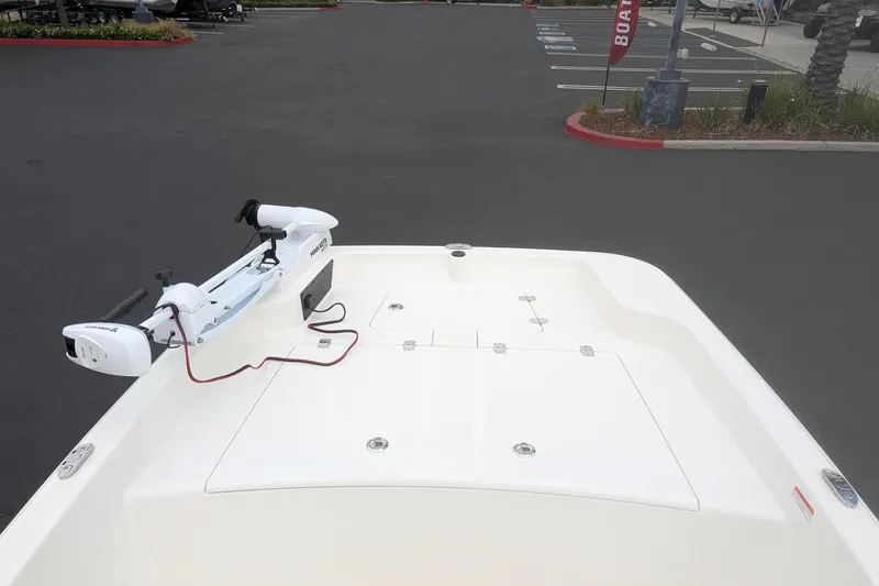Slide: The Image of 2026 Mako Pro Skiff 15 CC boat with trolling motor in parking lot. - 9