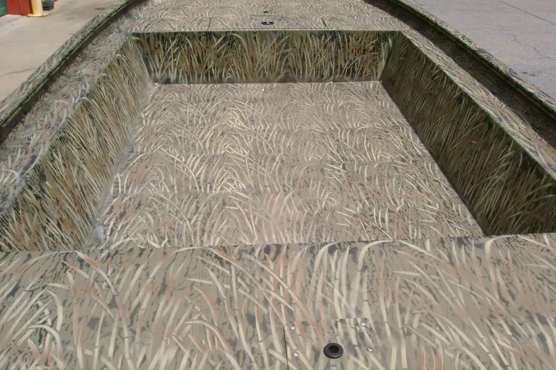 Slide: The Image of 2026 Tracker Grizzly 1754 Utility boat with camouflage interior design. - 5