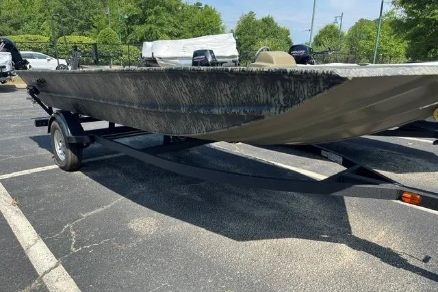 The Image of 2026 Tracker Grizzly 1754 Utility boat on trailer in parking lot. - 0