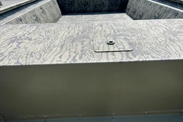 Slide: The Image of 2026 Tracker Grizzly 1754 Utility boat interior with camouflage pattern and utility hatch. - 4